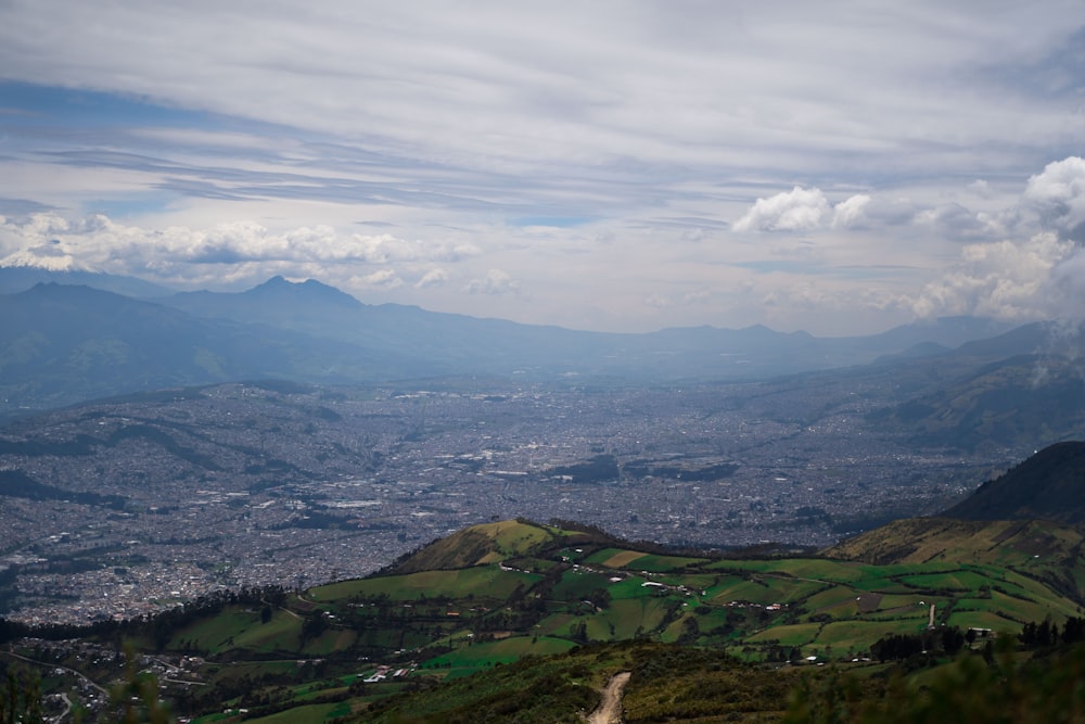 a scenic view of a city and mountains