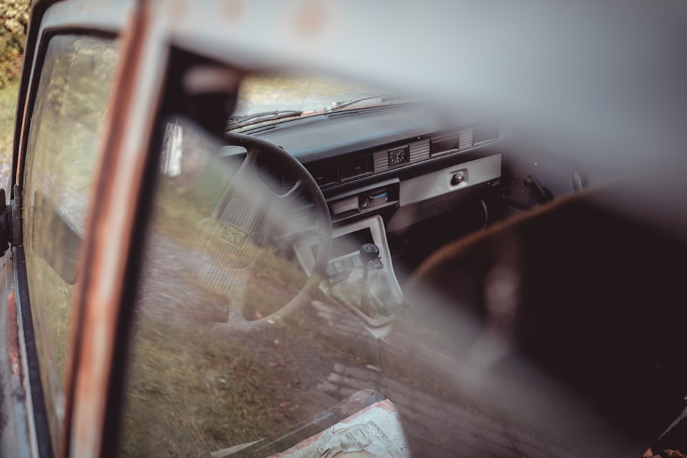 a car is parked in a grassy field