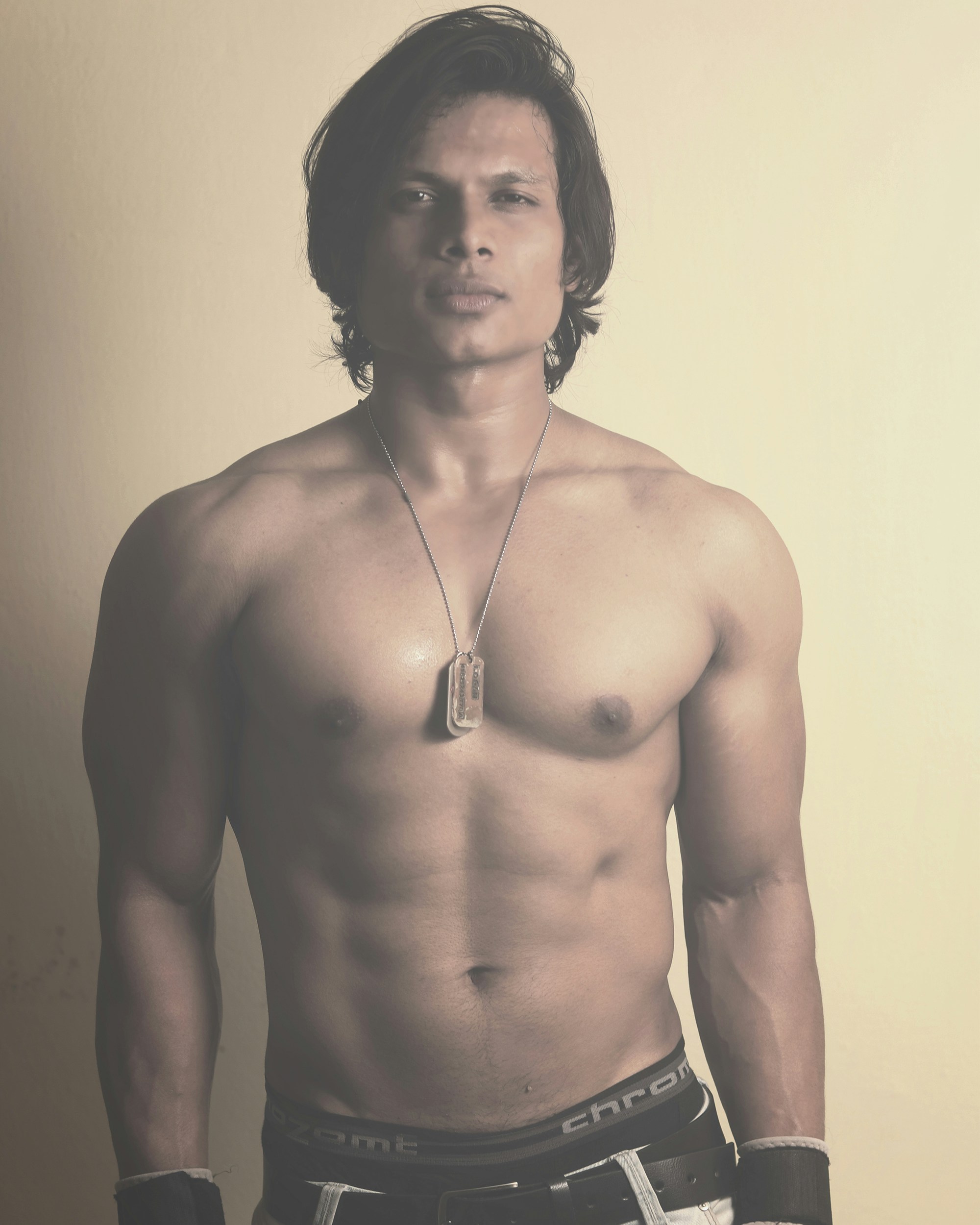 a shirtless man with no shirt standing in front of a wall