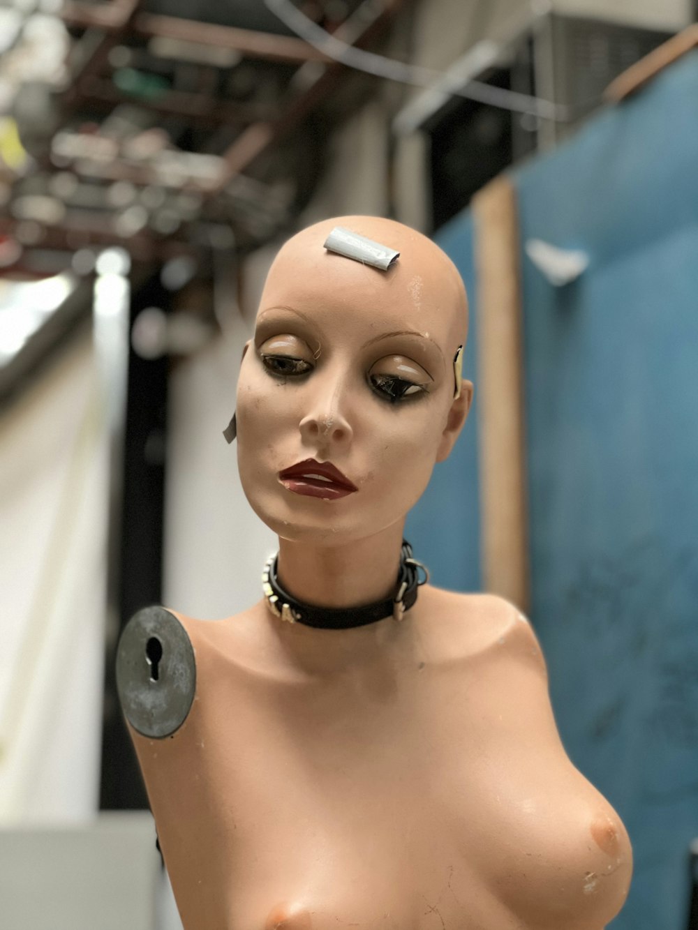 a mannequin with a piece of metal on it's head