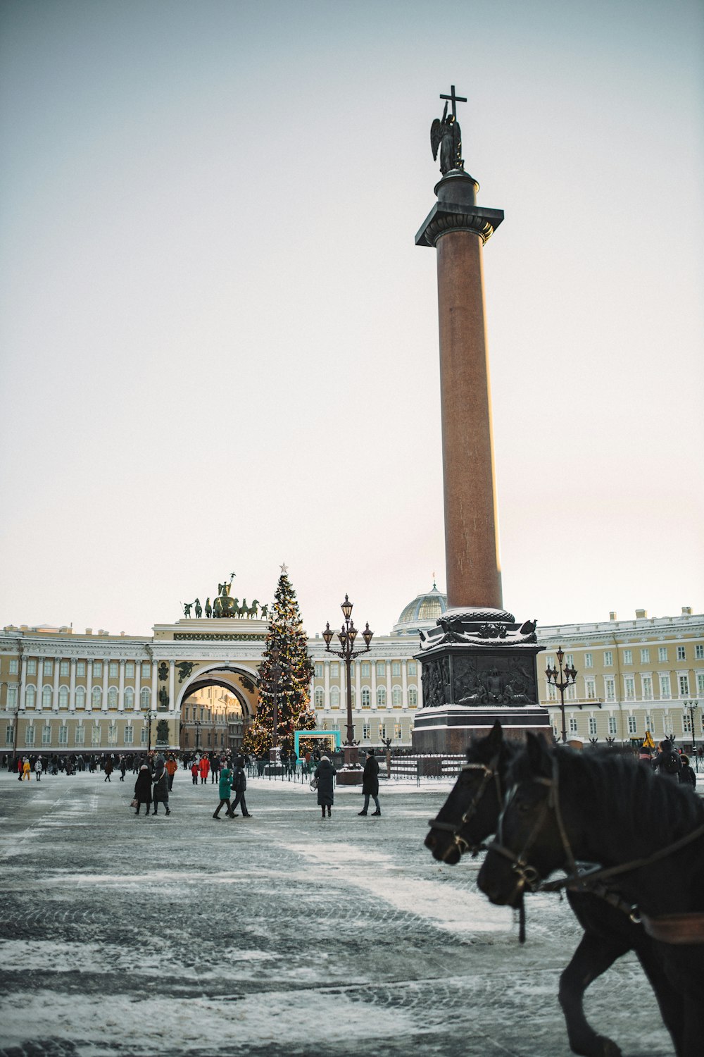 a horse drawn carriage in front of a tall building