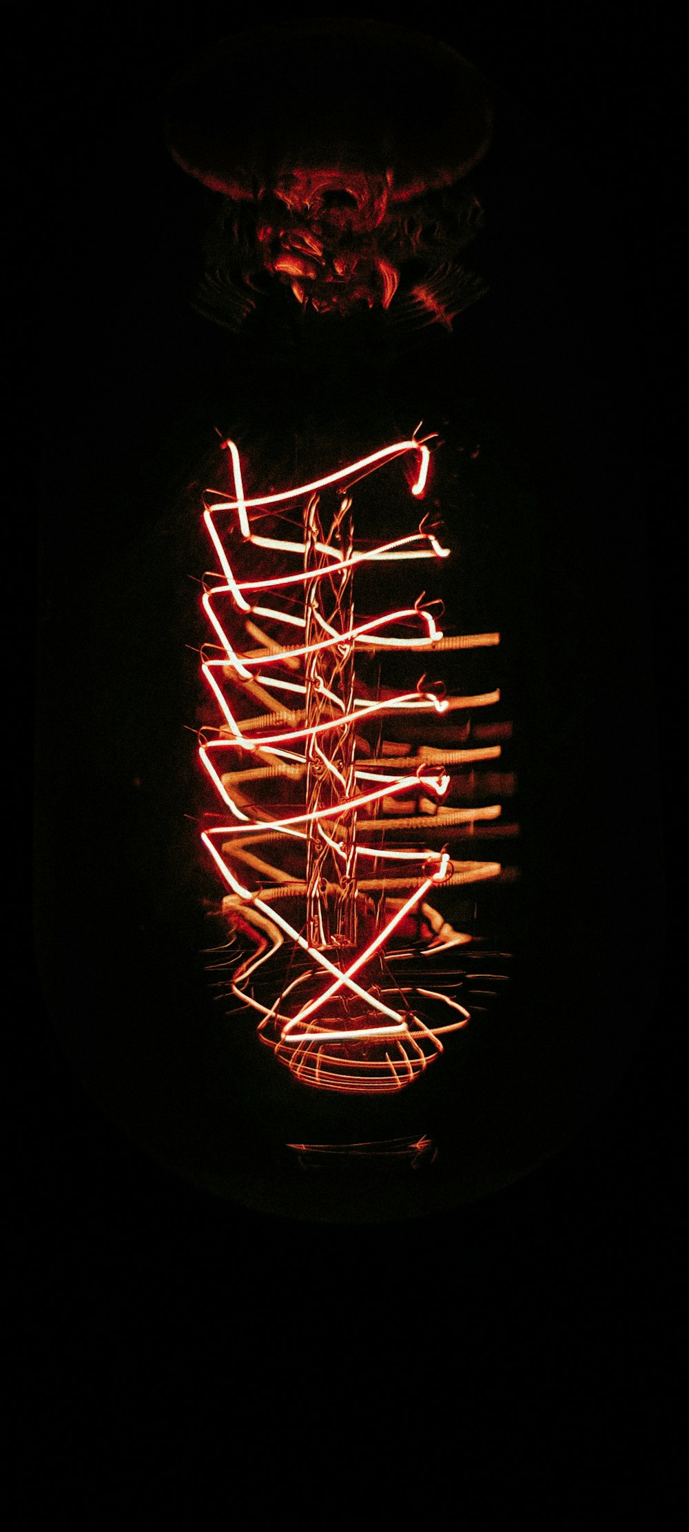 a lighted object in the dark with a black background