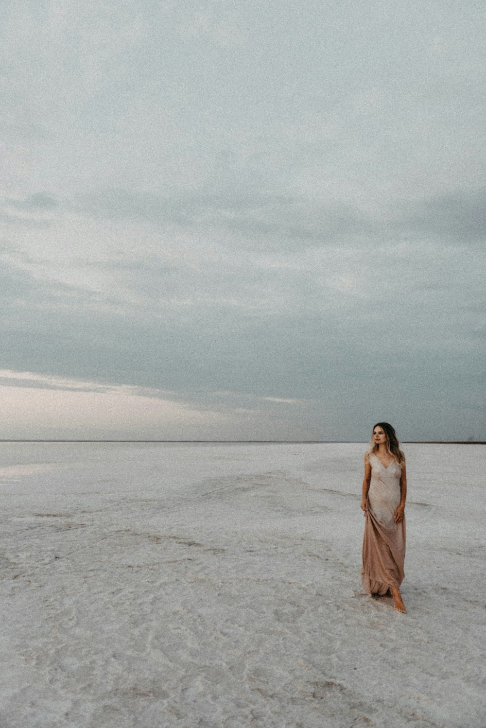 a woman standing in the middle of the desert