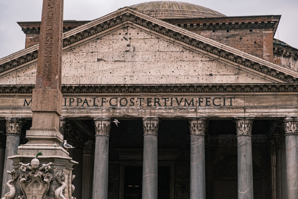 a large building with columns and a statue in front of it