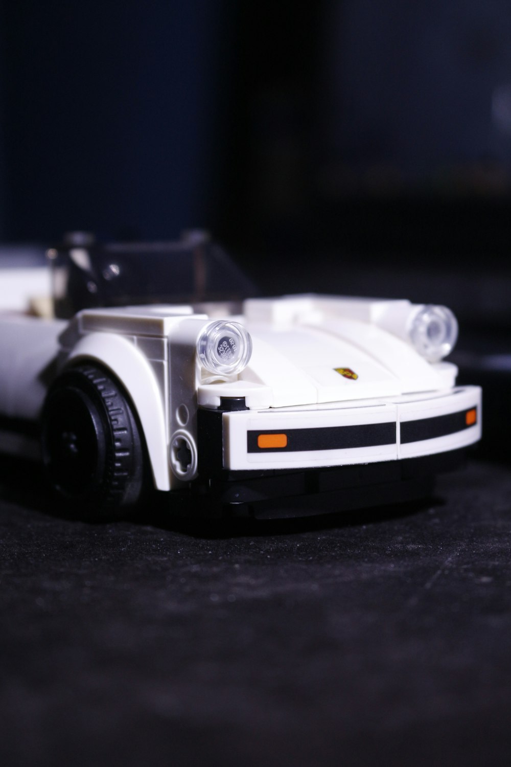 a white toy car sitting on top of a table