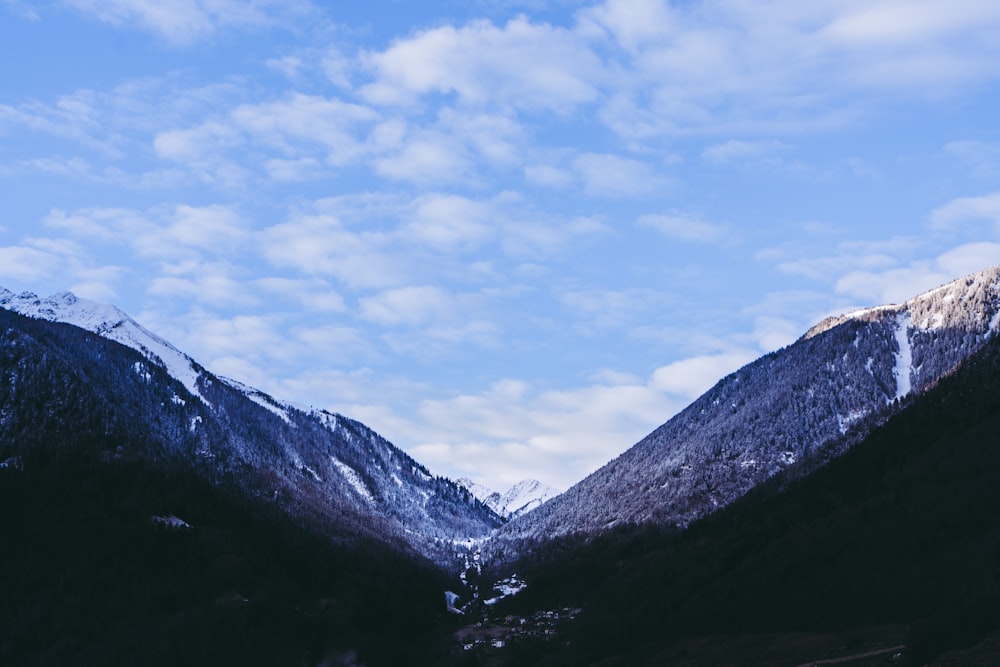 the mountains are covered in snow under a blue sky