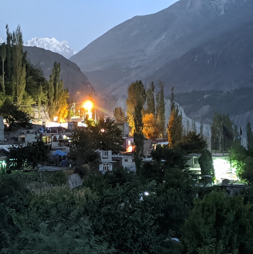 a night view of a village with mountains in the background