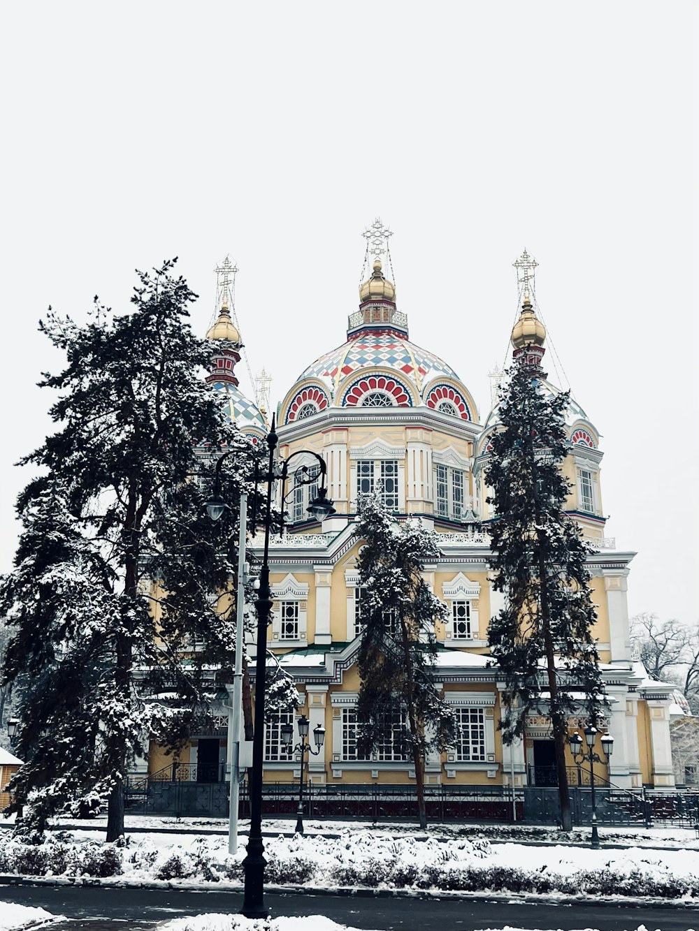 a large yellow building with a clock on the front of it