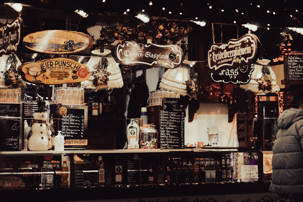 a man standing in front of a store filled with signs