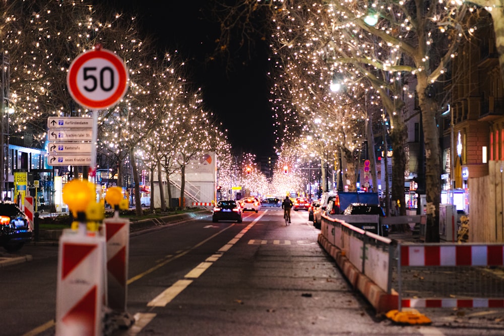 a street filled with lots of lights and trees