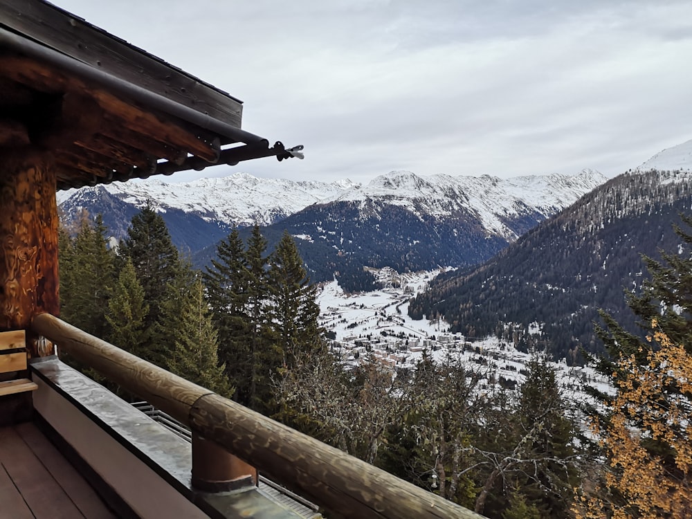 a balcony with a view of a snowy mountain valley