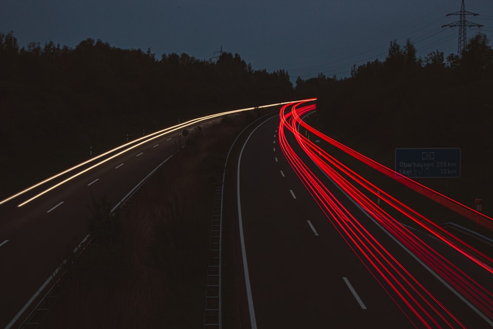 a long exposure photo of a highway at night