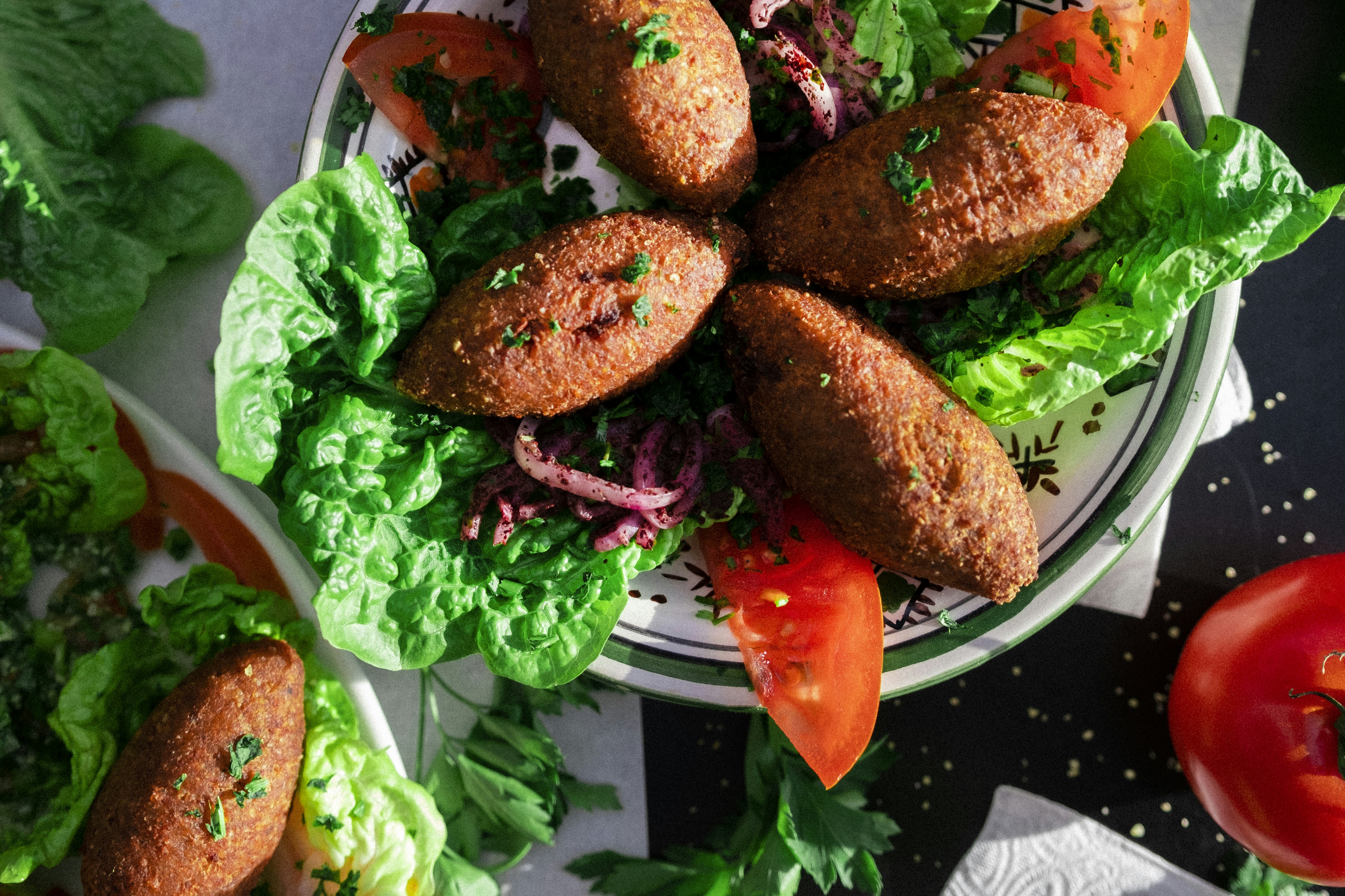 a white plate topped with meat patties and lettuce