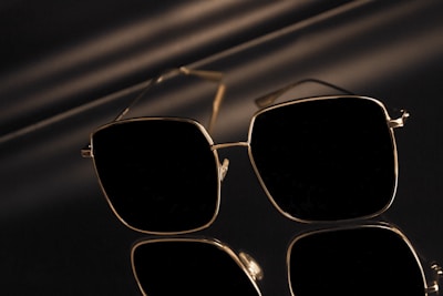 Sleek square sunglasses with polarized lenses resting on a marble surface