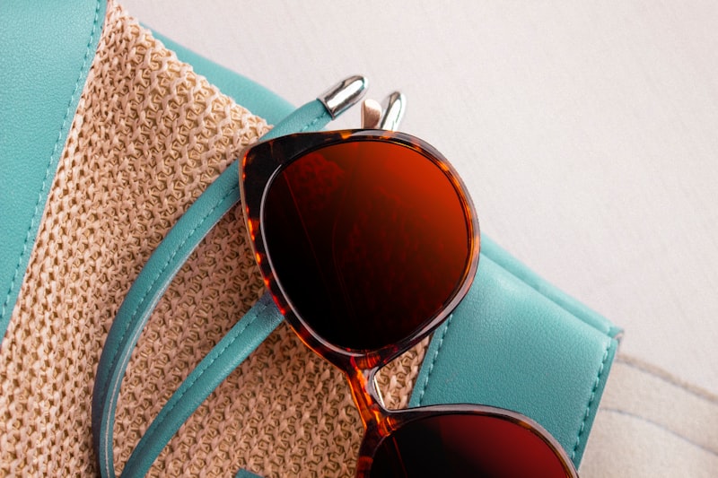a pair of sunglasses sitting on top of a purse