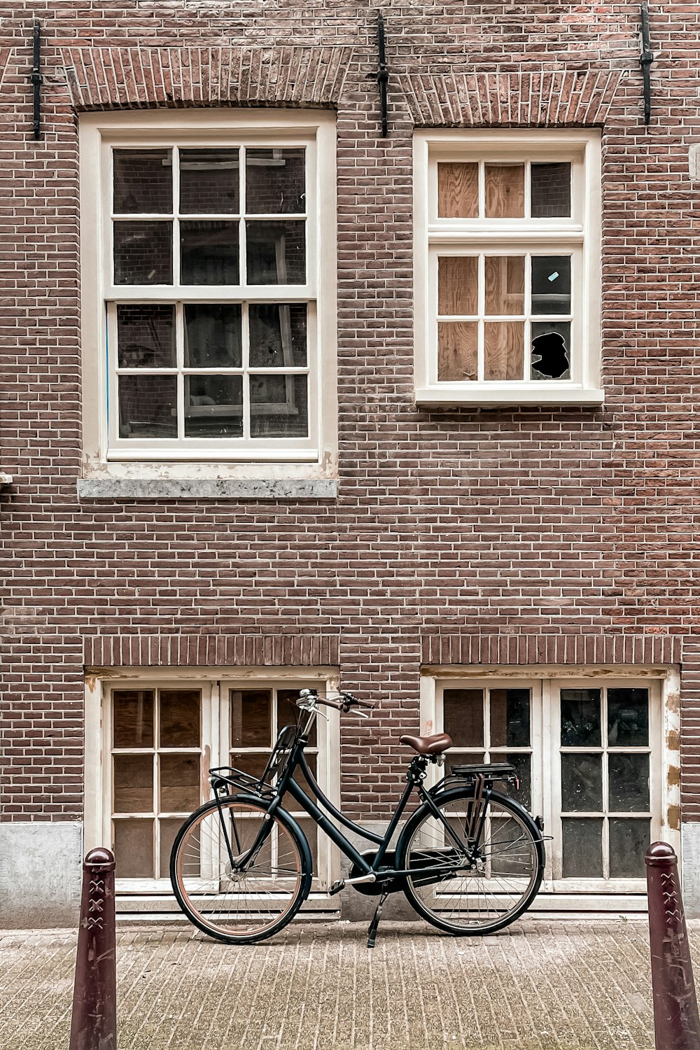 a bicycle parked in front of a brick building