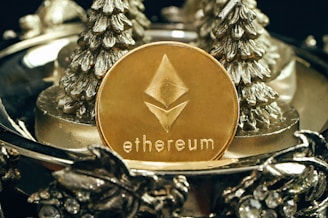 a gold ethereum coin sitting on top of a metal tray