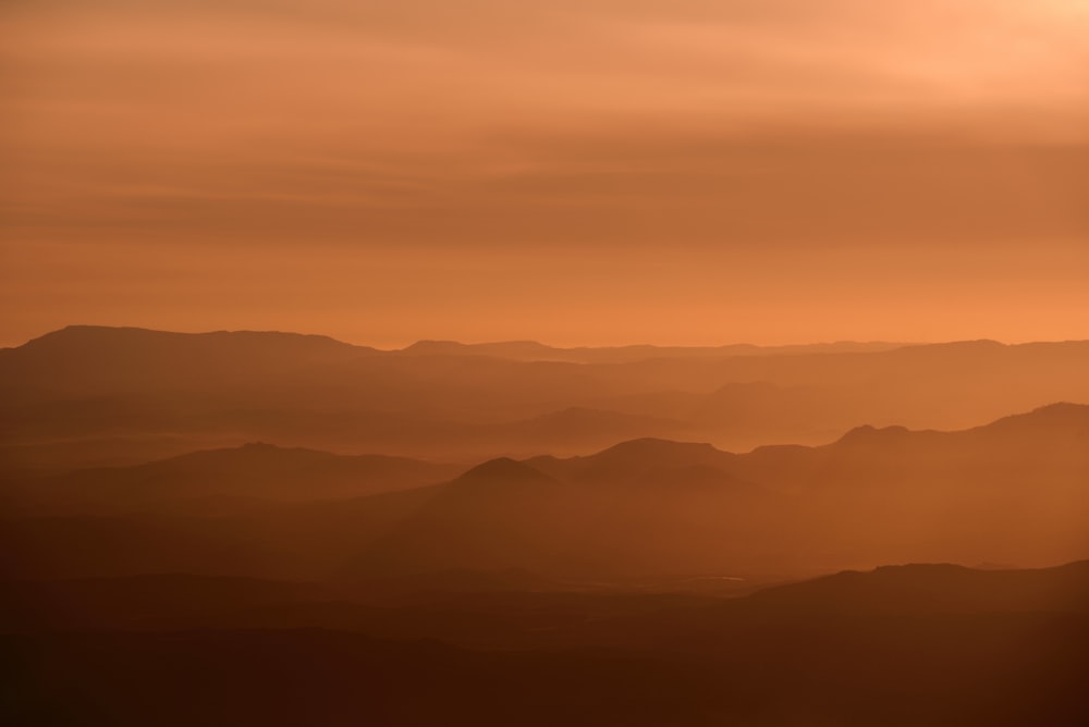 una vista di una catena montuosa al tramonto