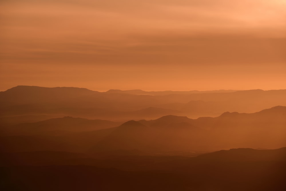 a view of a mountain range at sunset