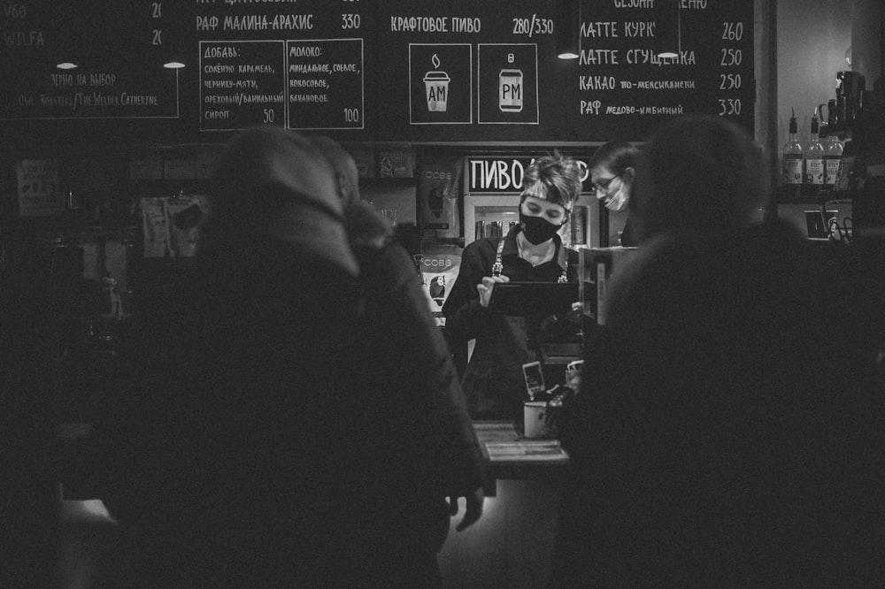 a group of people standing around a bar