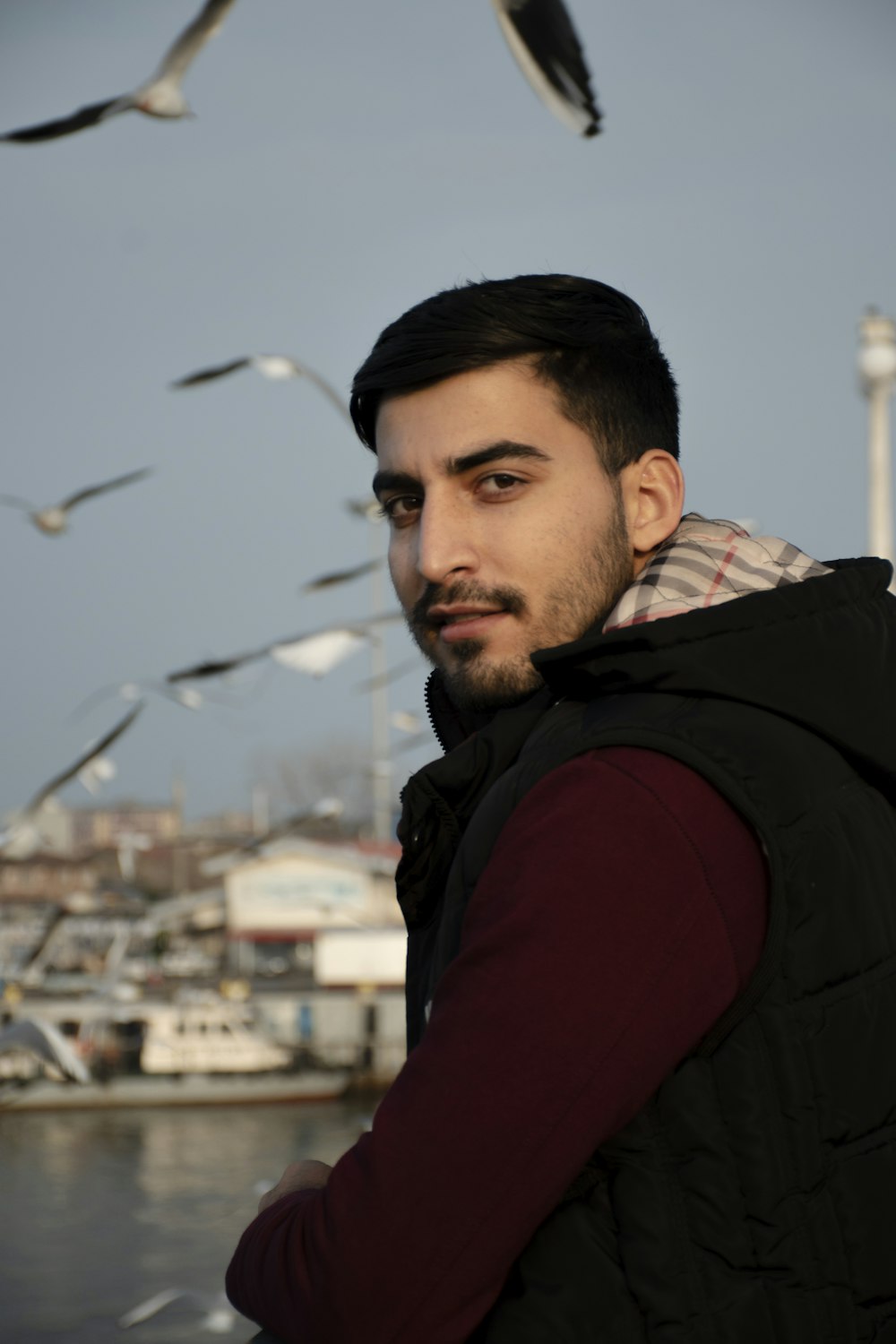 a man standing in front of a flock of seagulls