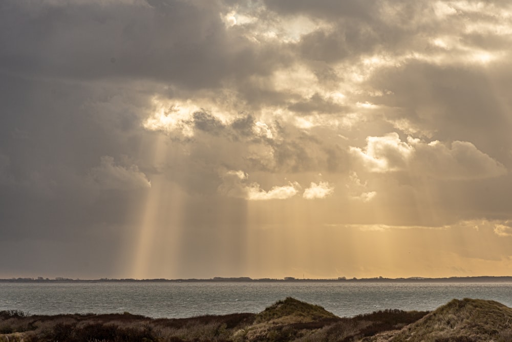 a large body of water under a cloudy sky