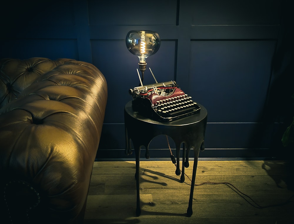 a table with a lamp on top of it next to a couch