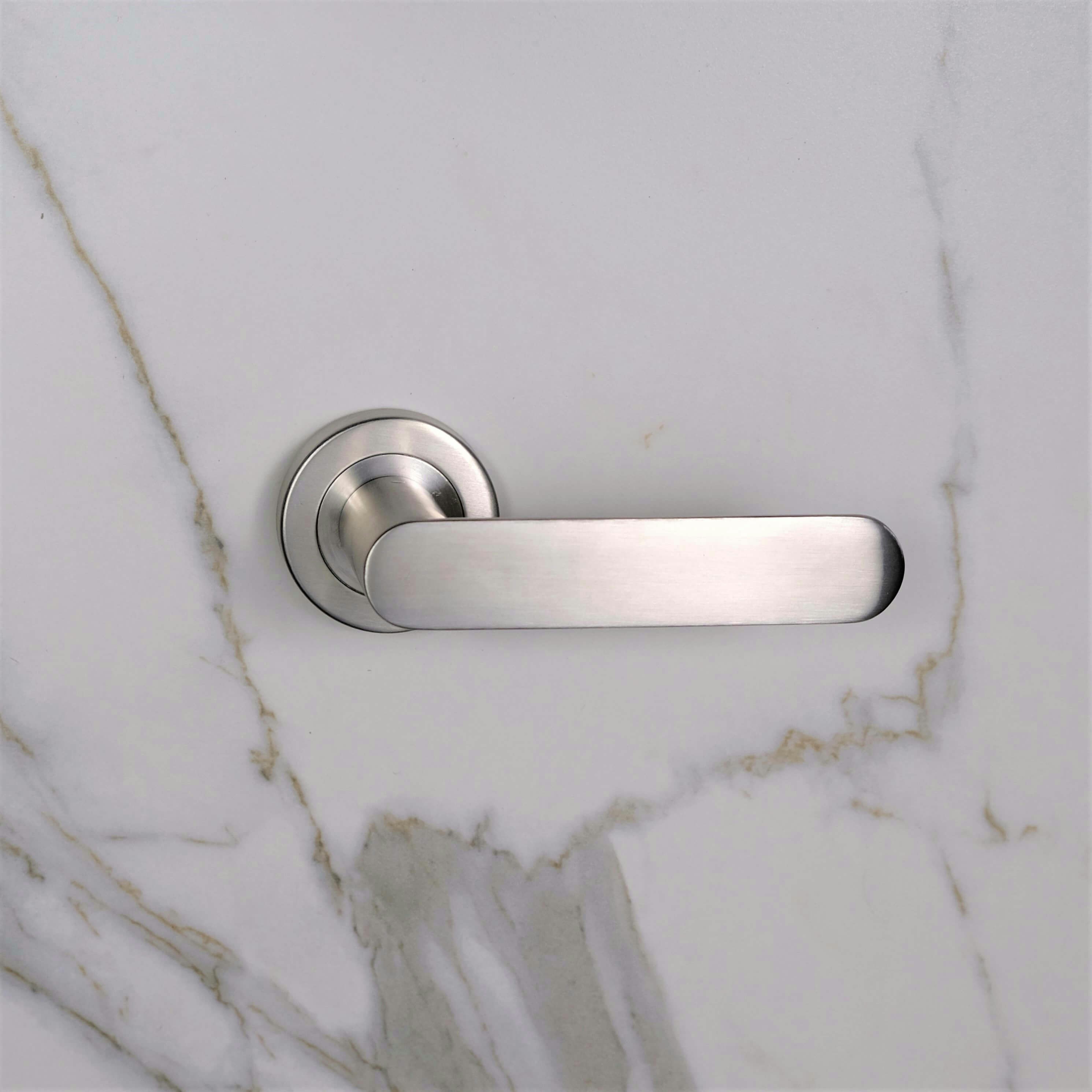 Rilievo premium door handle in brushed nickel finish on white door