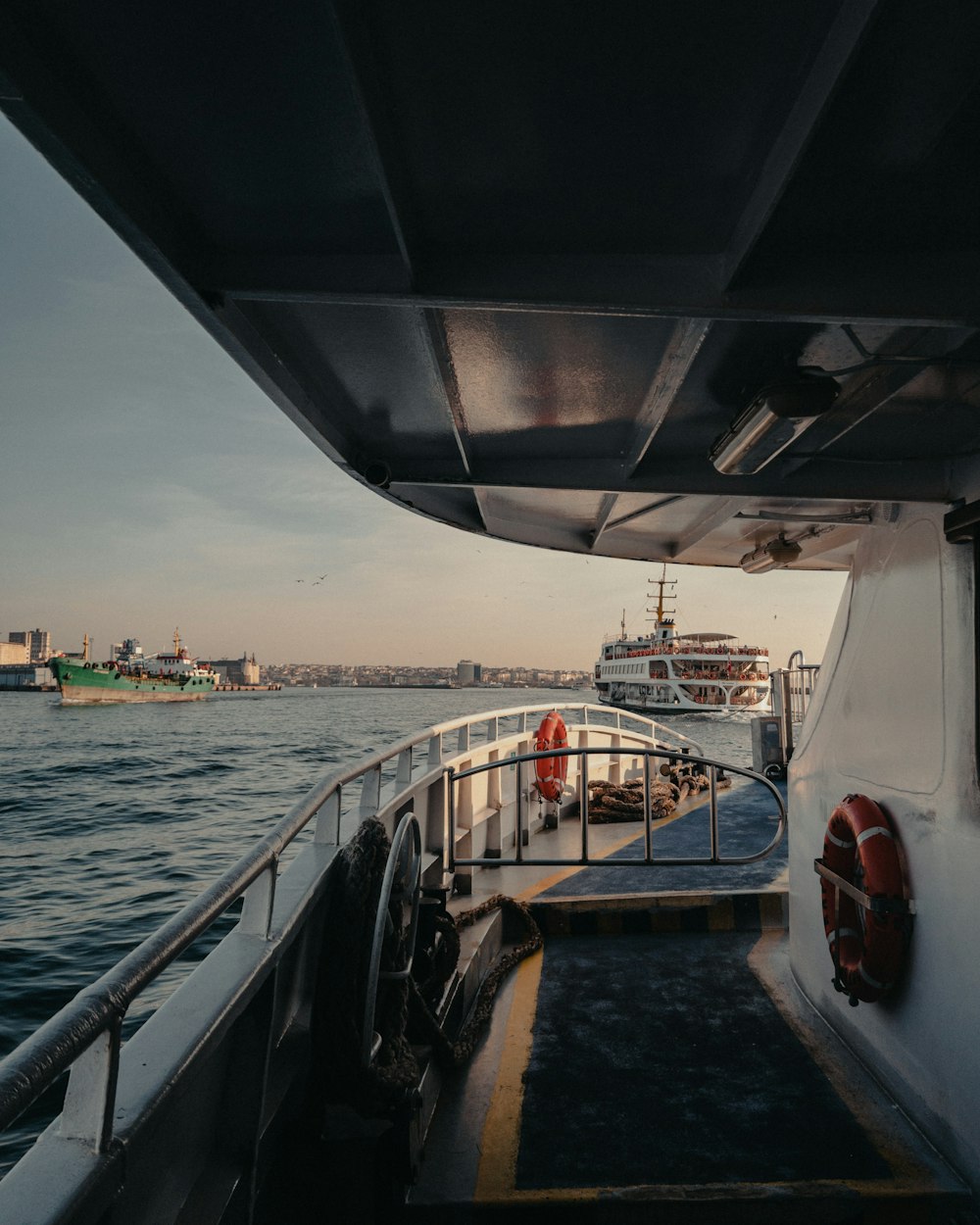 a boat traveling down a river next to a large body of water