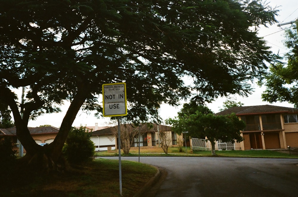 a yellow and white street sign sitting on the side of a road