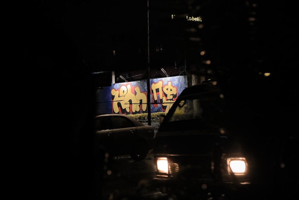 a couple of cars that are sitting in the dark