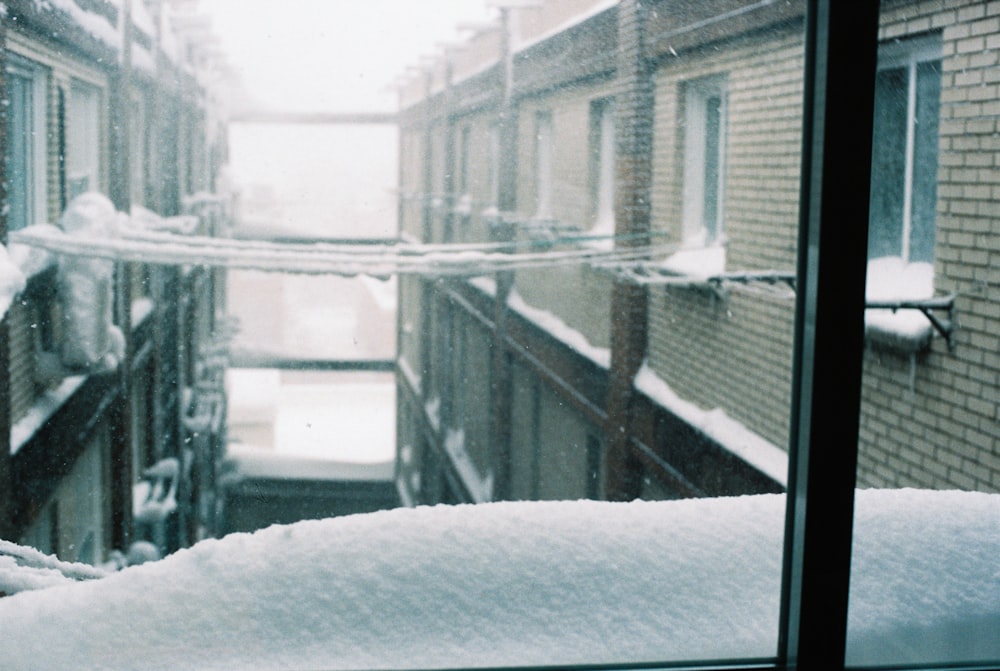 a view of a snowy street from a window