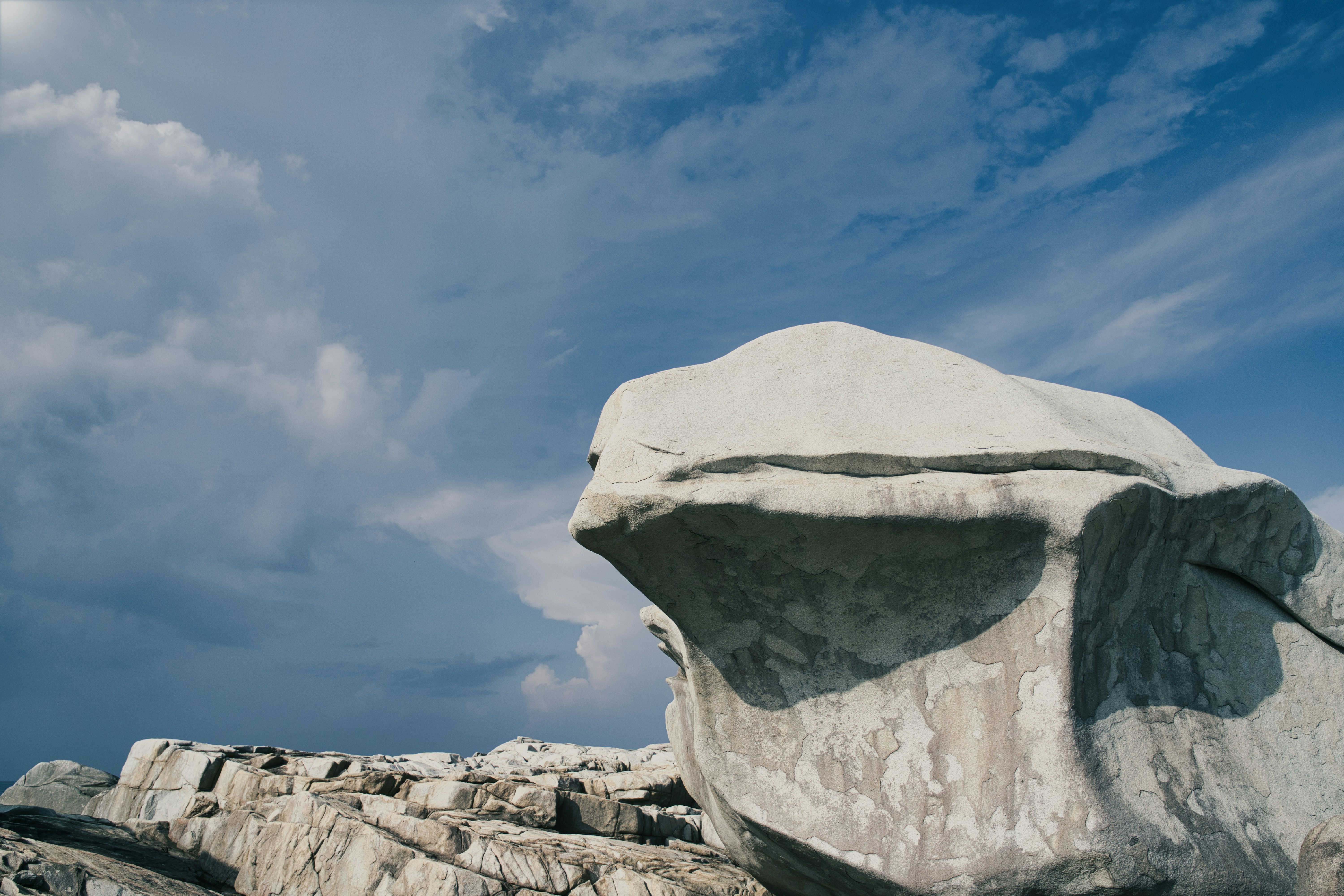 a large rock sitting on top of a rocky hillside