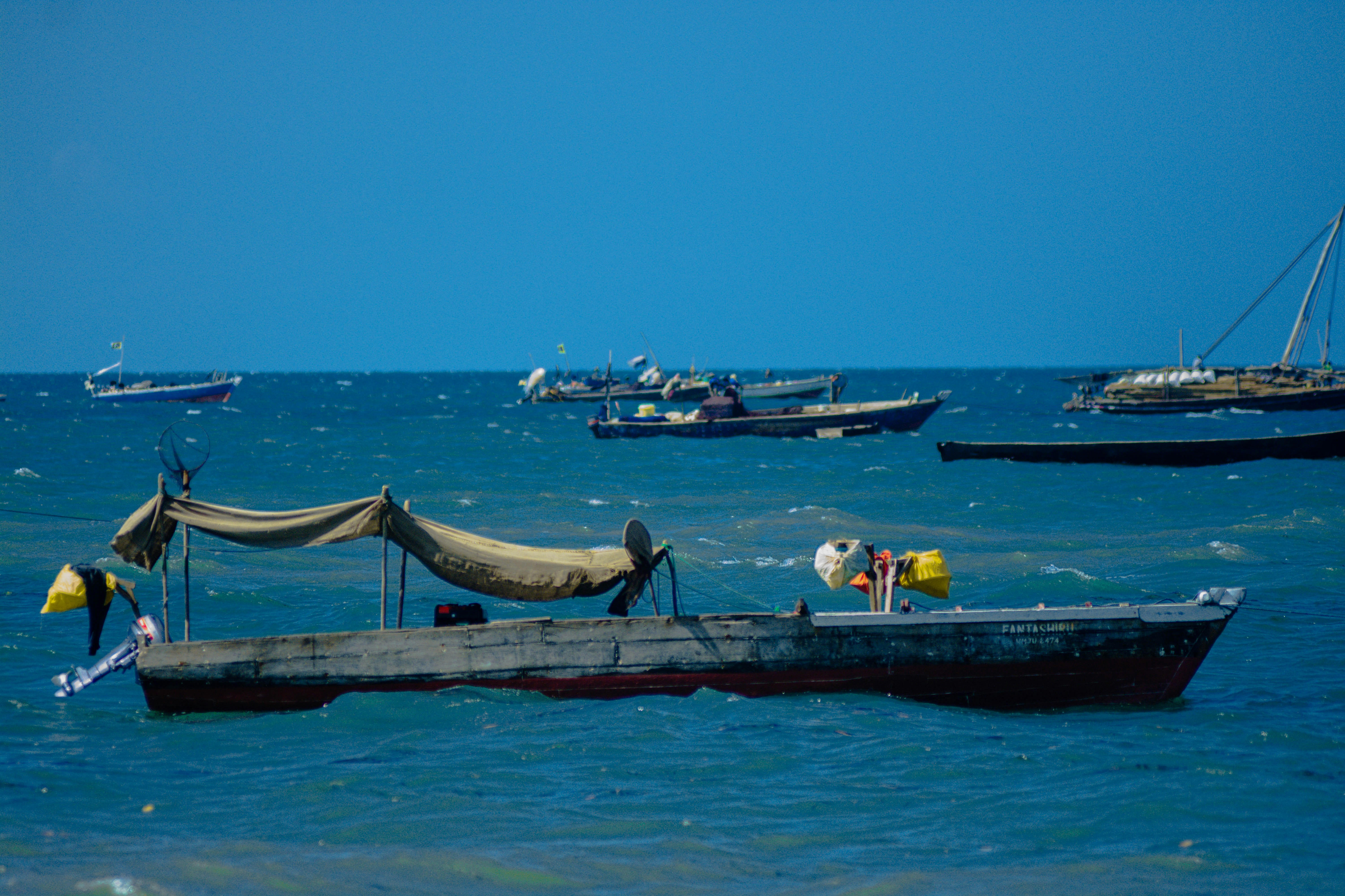 a group of boats floating on top of a large body of water