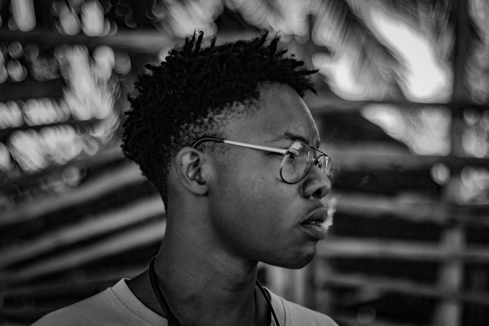 a black and white photo of a man with glasses