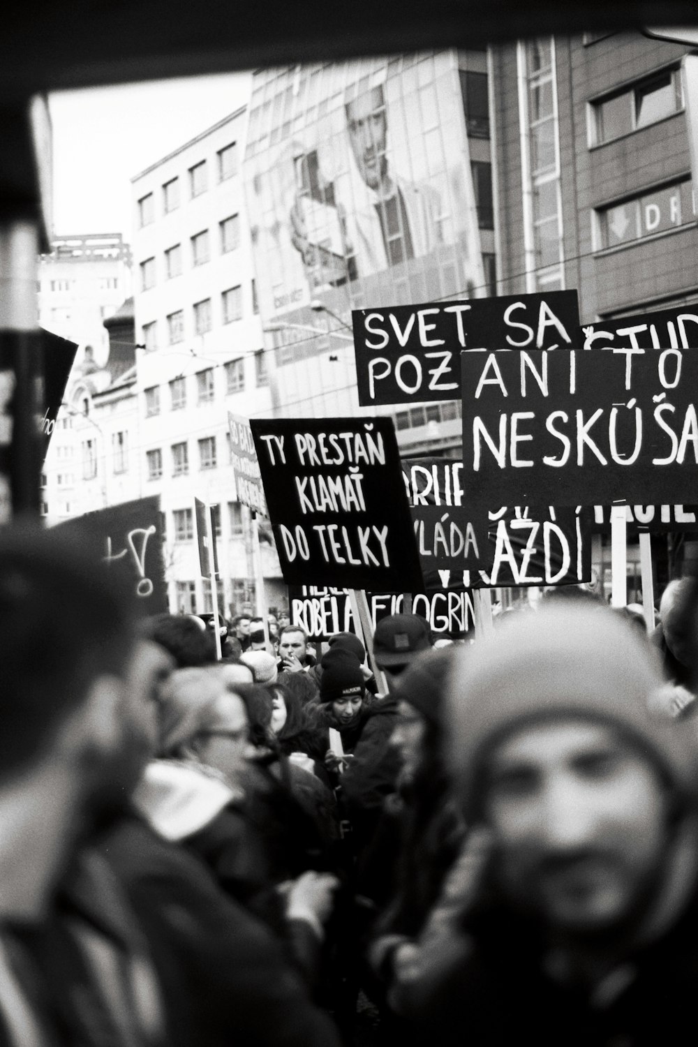 a large group of people holding signs in the street