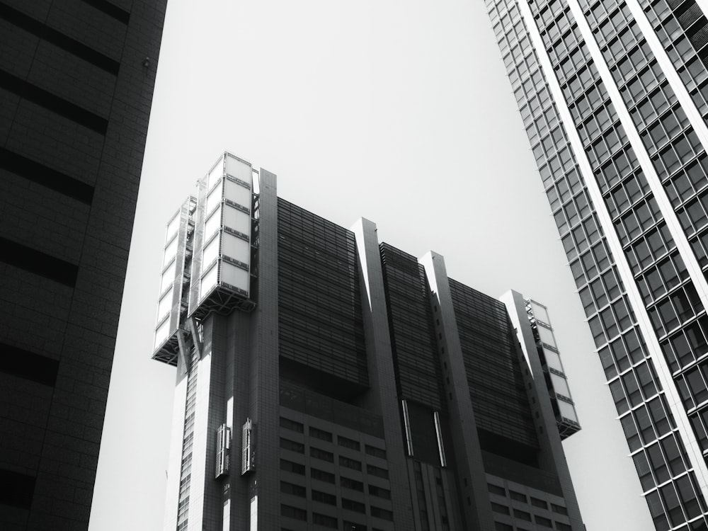 a black and white photo of tall buildings