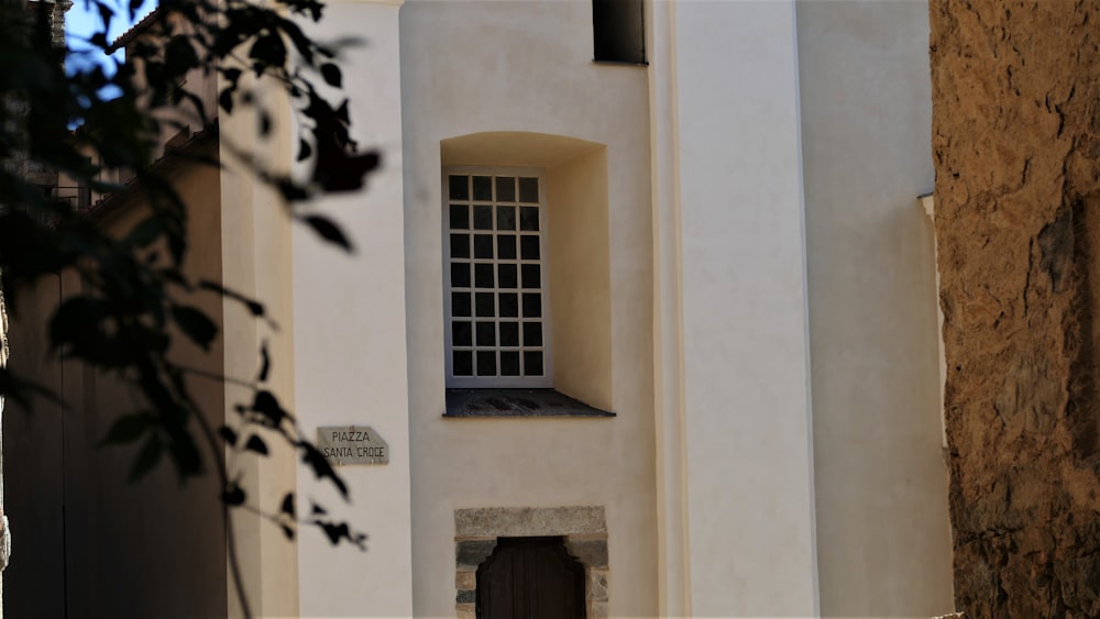 a white building with a window and a door