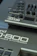 Close-up view of parts of Roland synthesizer models JD-08 and JD-800. The image features the control buttons, knobs, and sliders of the instruments along with the branding and model names on the panels.