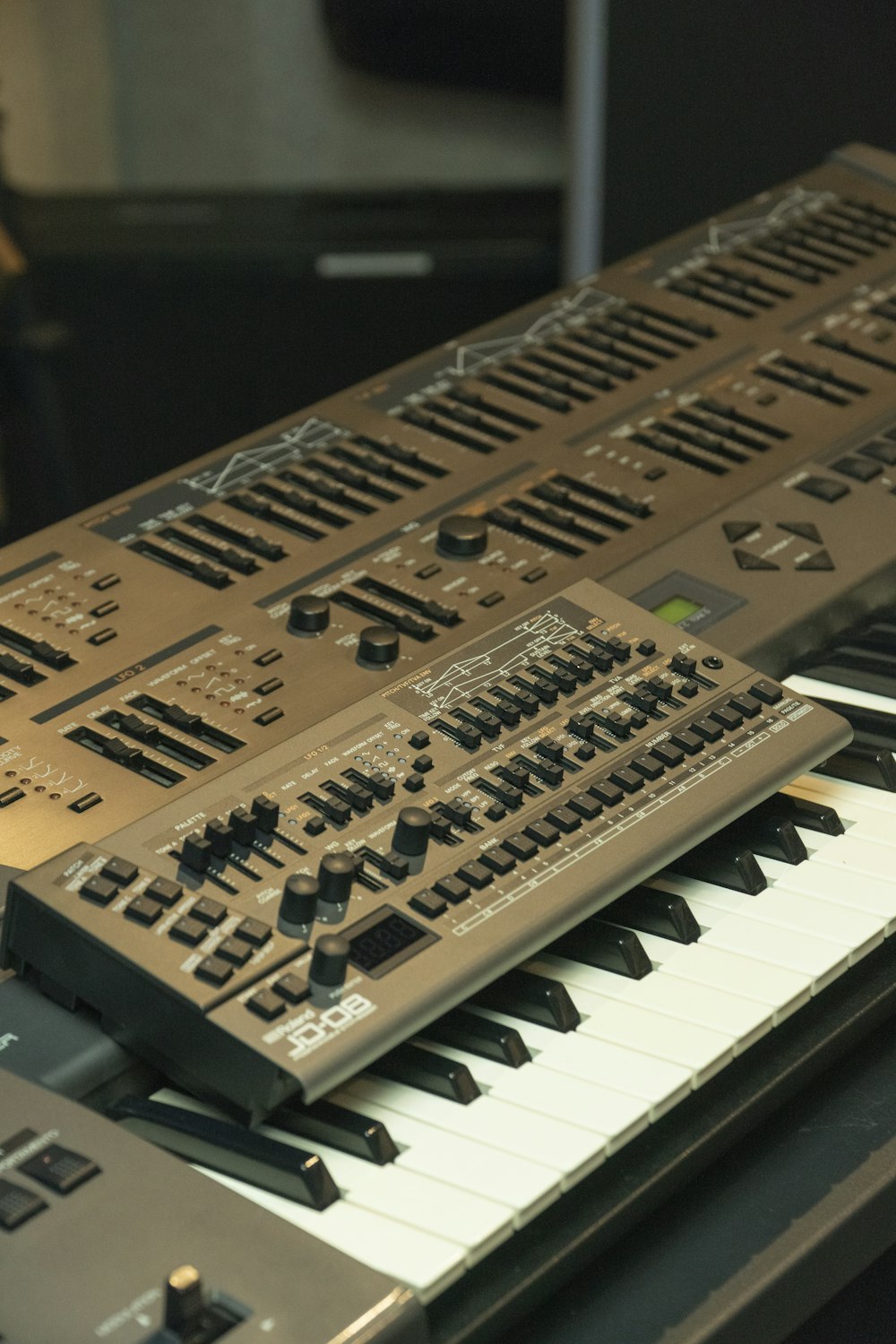 a close up of a keyboard with a person in the background