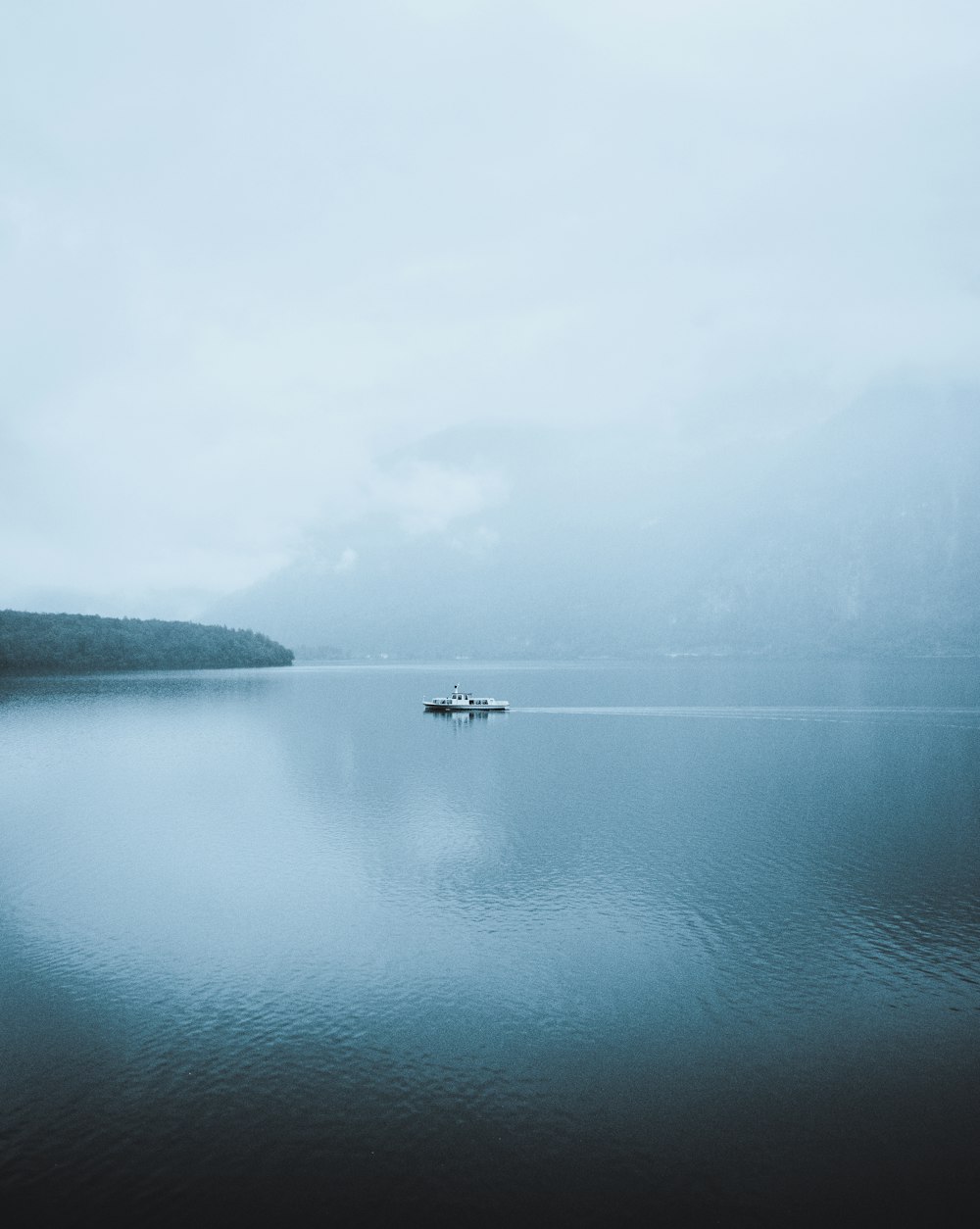 a small boat floating on top of a large body of water