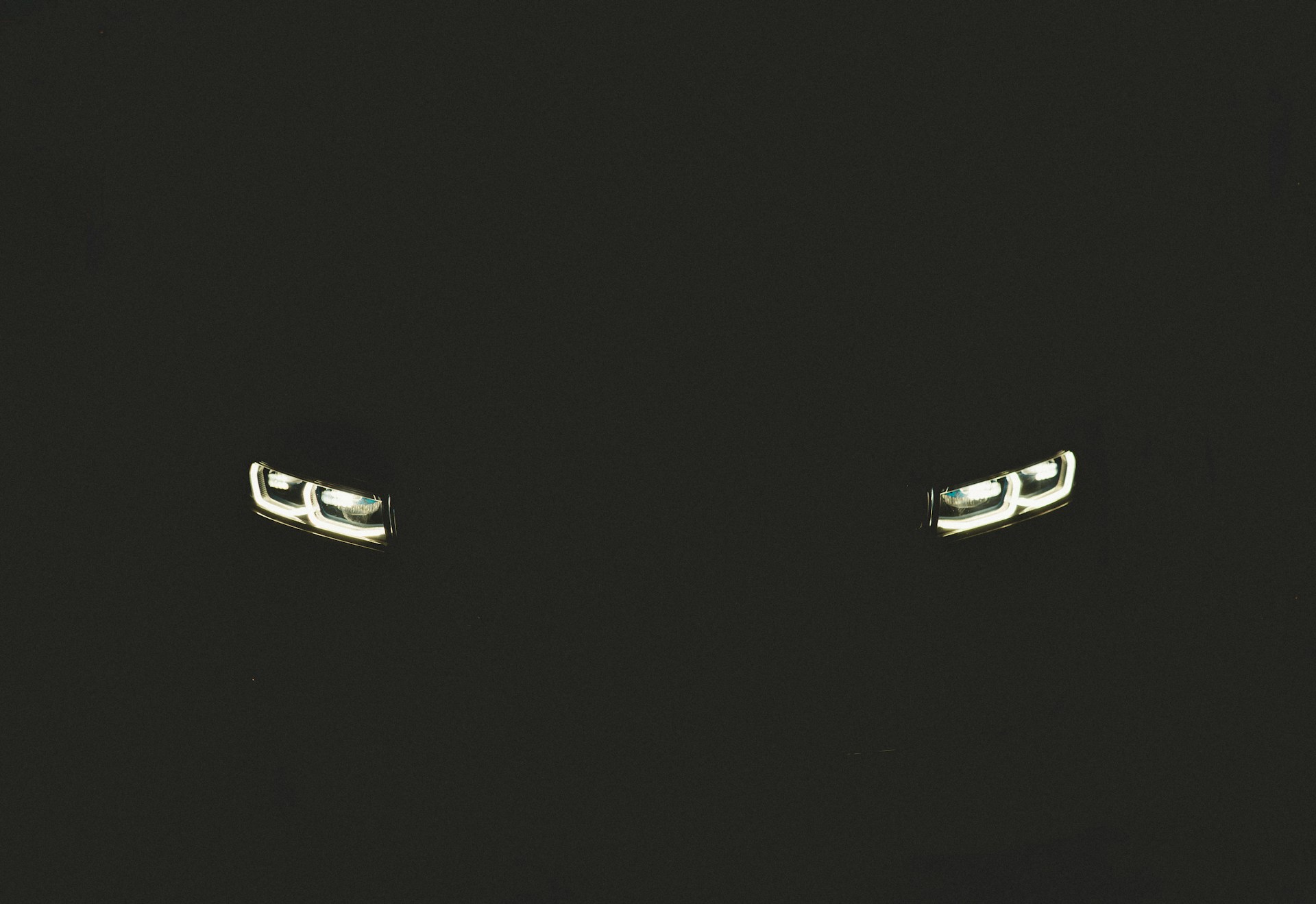 a pair of silver cufflinks on a black background