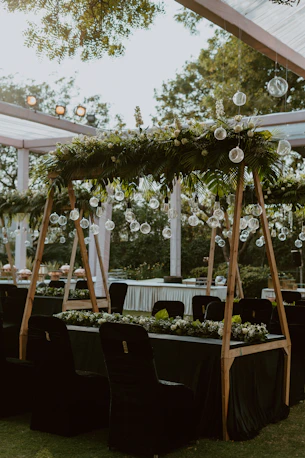 a wedding reception setup with black tables and white linens