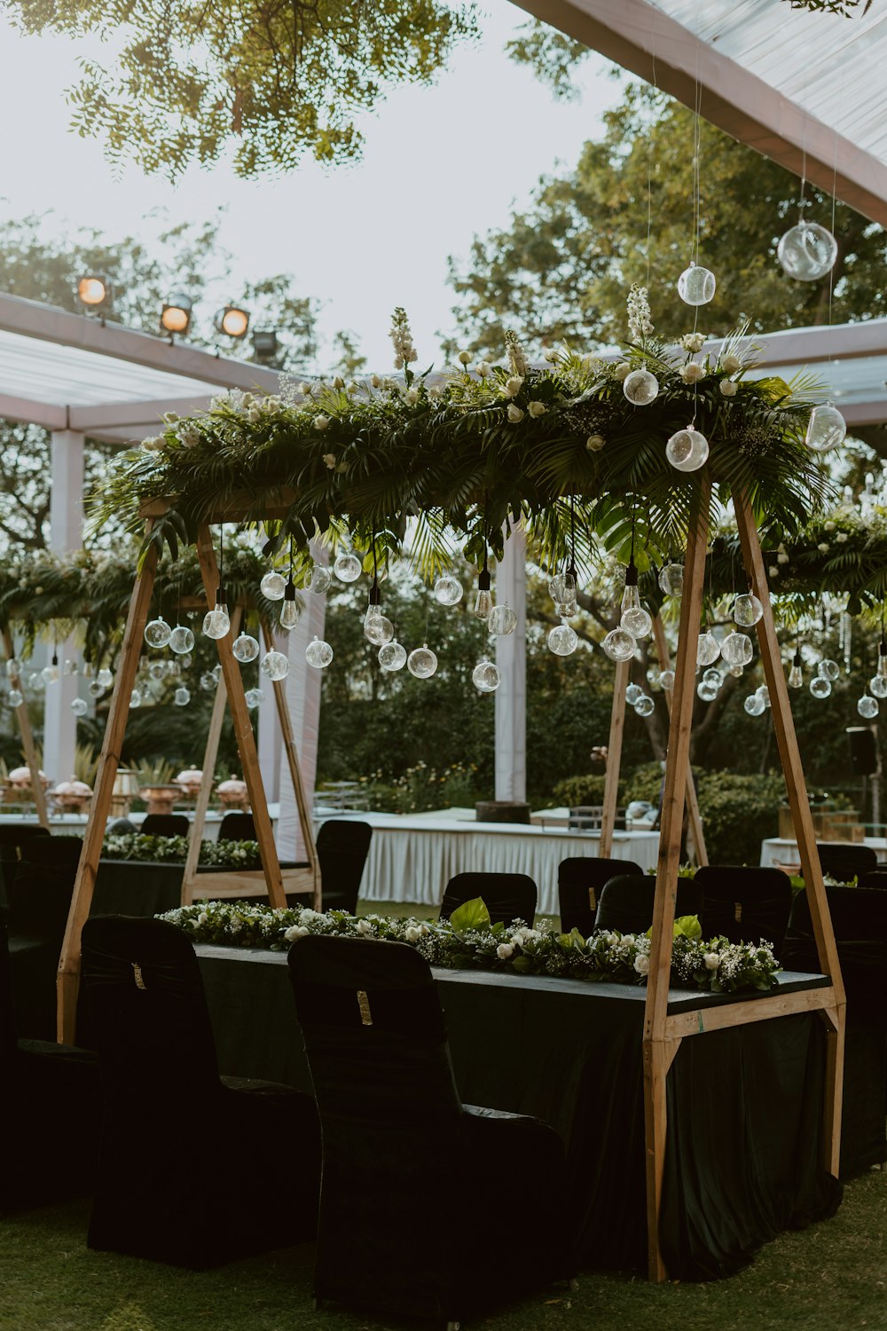 a wedding reception setup with black tables and white linens
