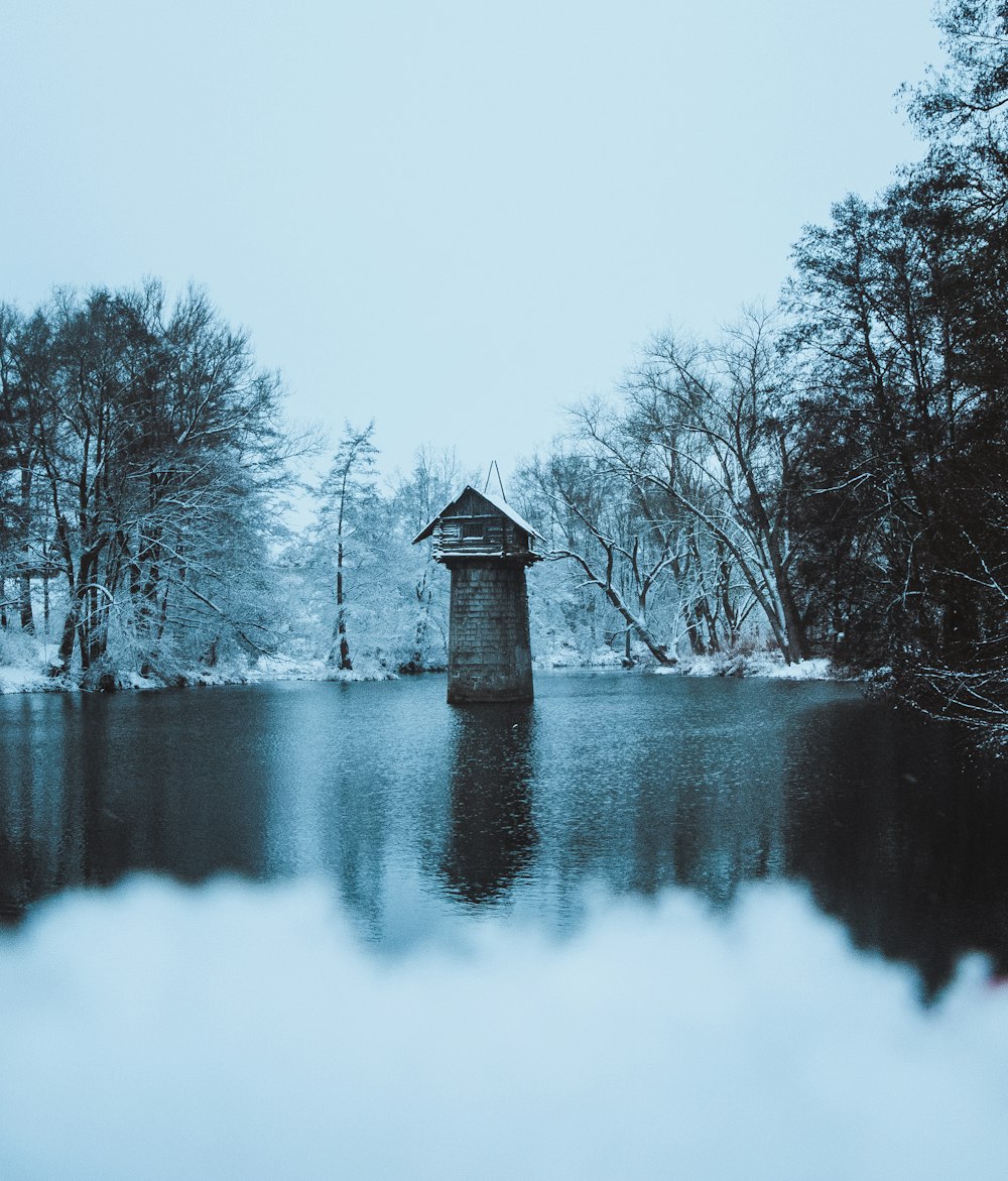 a small building sitting on top of a lake