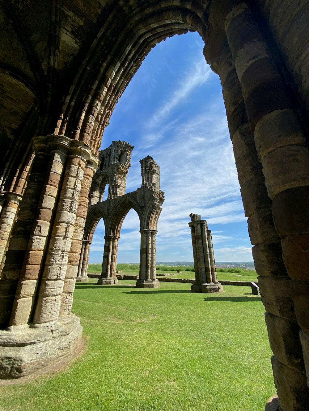 the ruins of an old building with a blue sky in the background