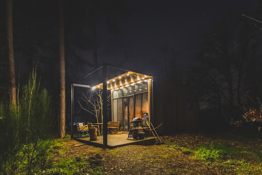 a man is sitting in a tiny cabin in the woods