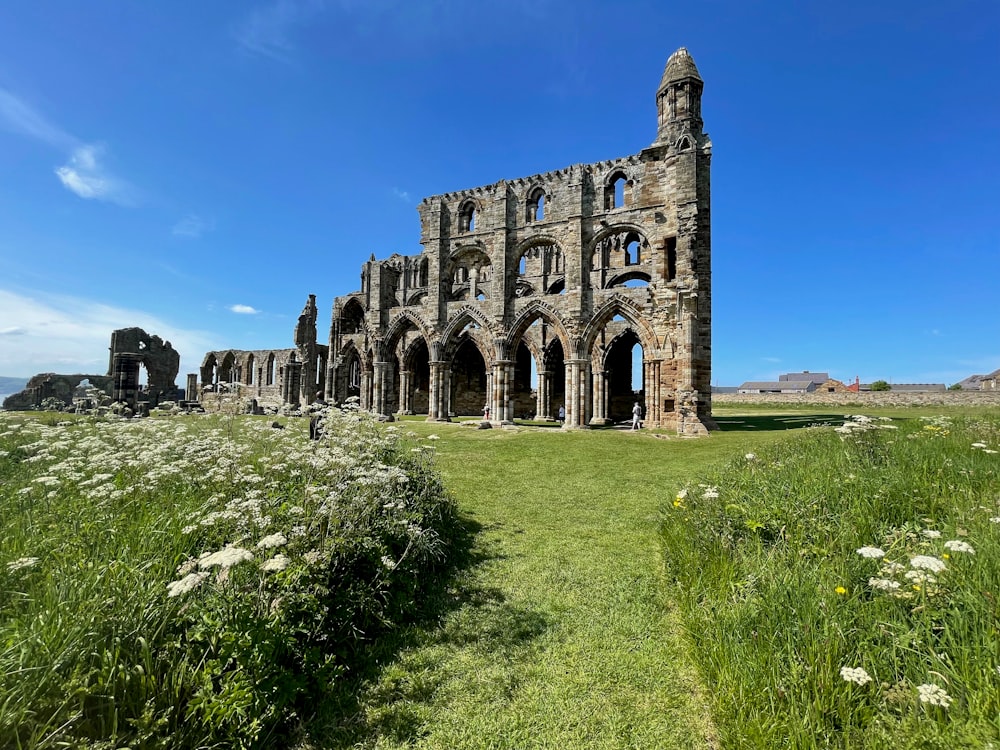 the ruins of an old church in the middle of a field