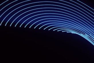 Curved, glowing blue lines on a dark background create a sense of motion and energy.