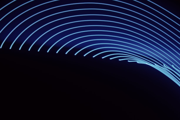 Abstract glowing golden lines on a dark background symbolizing innovation and technology.